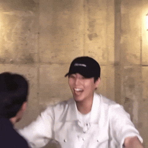 a man wearing a black hat with the word supreme on it is laughing