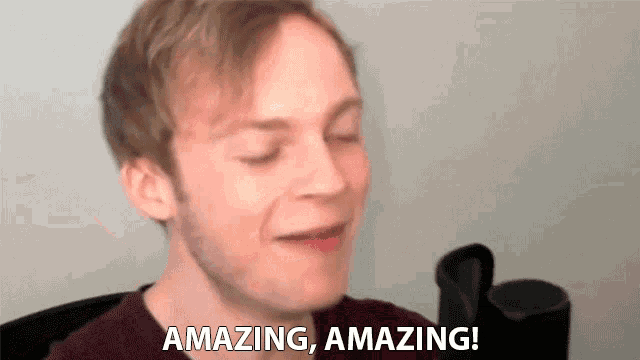 a man says " amazing amazing " in front of a white wall