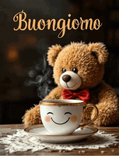a teddy bear sits next to a cup of coffee with a smiling face