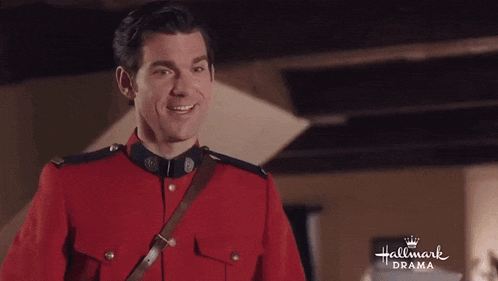 a man in a red uniform is smiling in a hallmark drama ad .