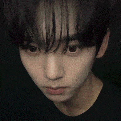 a close up of a person 's face with a dark background