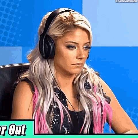 a woman wearing headphones is sitting in a chair and looking at the camera .
