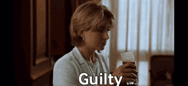 a woman is holding a glass of beer and the word guilty is above her