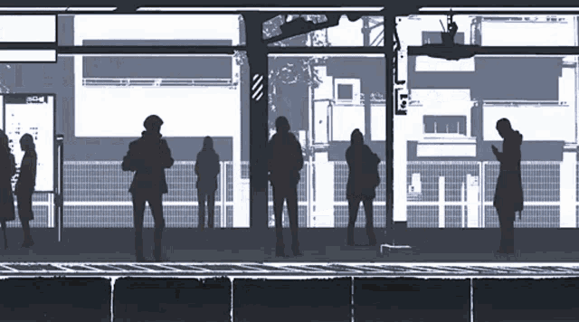 a group of people are waiting at a bus stop