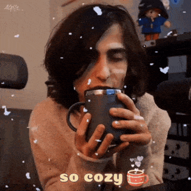 a man is drinking from a mug with the words so cozy written on the bottom