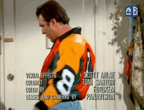 a man is wearing a colorful jacket with the number 8 on it