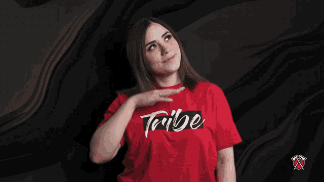 a woman wearing a red t-shirt that says tribe on it