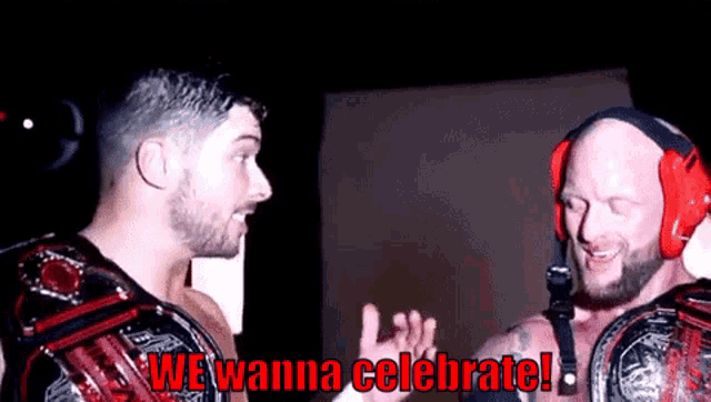 two men wearing headphones are standing next to each other and one of them is saying we wanna celebrate !