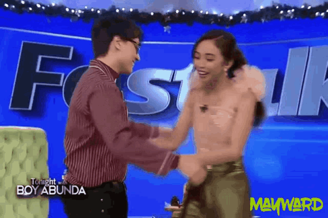 a man and woman are shaking hands in front of a sign that says fastik
