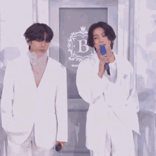 two men are standing in front of a door that says maison fondee