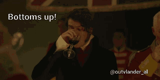 a man drinking from a glass with the words bottoms up below him