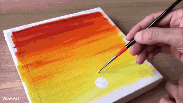 a person is painting a sunset on a canvas with the words wow art below