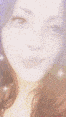 a close up of a woman 's face with a blurred image
