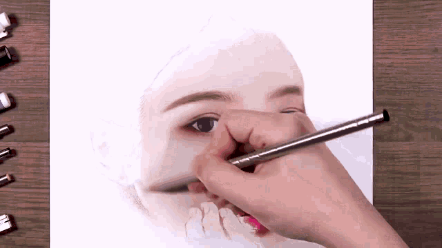 a person is drawing a girl 's face with a pencil