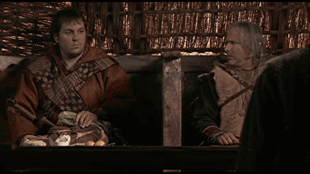 two men are sitting at a table with the words je sais pas j ' ecouais pas on the bottom