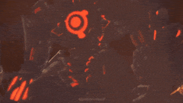 a close up of a person holding a gun in a dark room with red lights coming out of it .