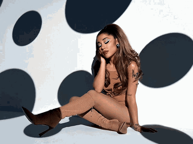 a woman is sitting on the floor with her legs crossed