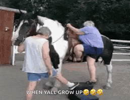 a man and a woman are standing next to a horse with the caption `` when yall grow up '' .