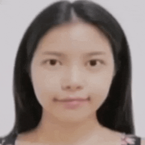 a close up of a woman 's face with long black hair without makeup .