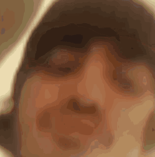 a close up of a person 's face with a hood on