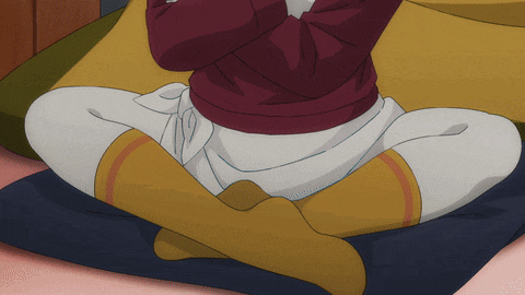 a person is sitting on a pillow with their feet crossed