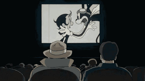 a group of people are watching a cartoon in a theater