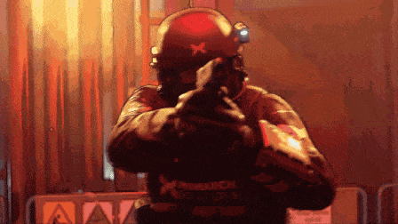 a pixelated image of a man holding a gun with the word monarch on the back of his jacket