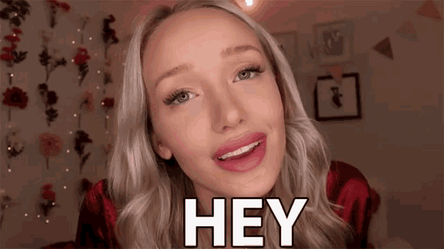 a woman with braces on her teeth is smiling and says hey