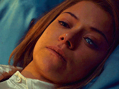 a close up of a woman laying down with a tear coming out of her nose