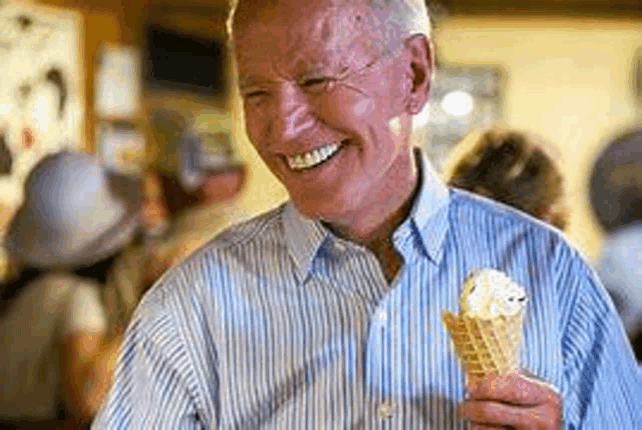 an older man is holding an ice cream cone in his hand and smiling .