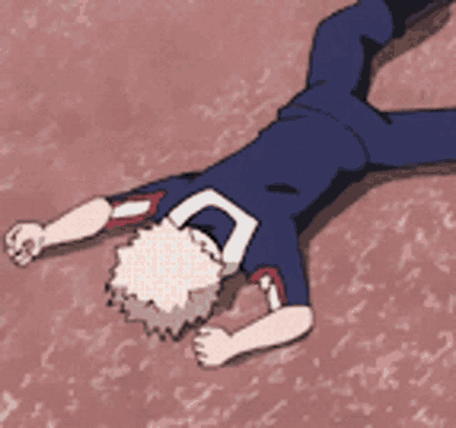 a person is laying on their back on the ground with their fist in the air .