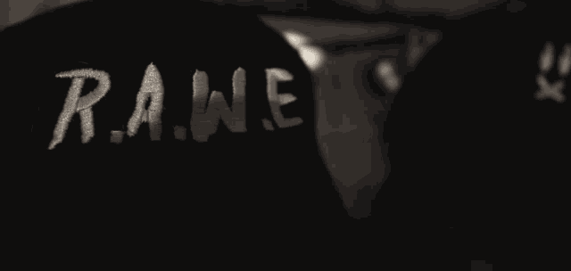a person wearing a black sweatshirt that says rune on the sleeve
