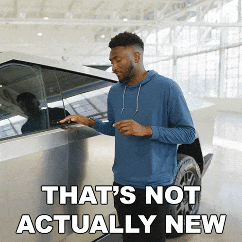 a man standing next to a car that says " that 's not actually new " on the bottom