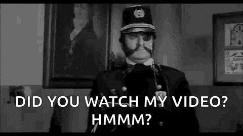 a black and white photo of a police officer with a mustache and a hat .