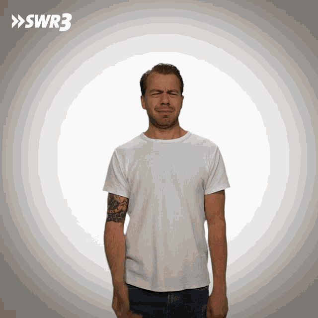 a man with a tattoo on his arm is making a funny face in front of a swr3 sign