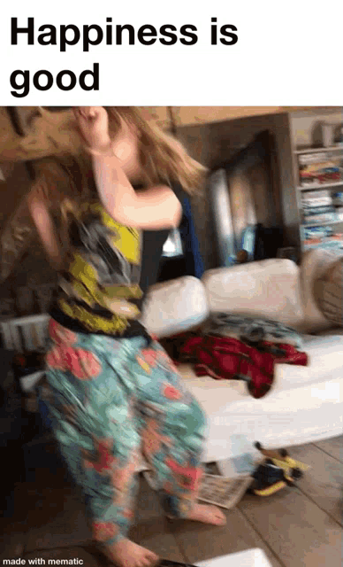a woman is dancing in a room with the words happiness is good on the bottom