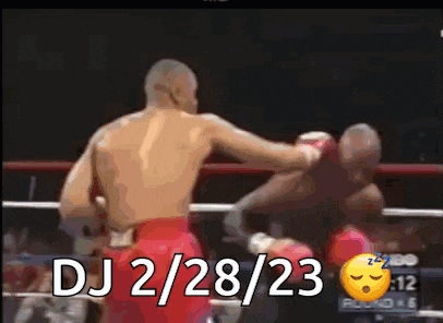 a man is boxing another man in a boxing ring and the date is dj 2/28/23 .