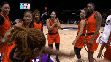 a group of female basketball players including number 14