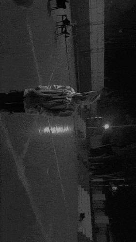 a black and white photo of a person wearing a spider man costume