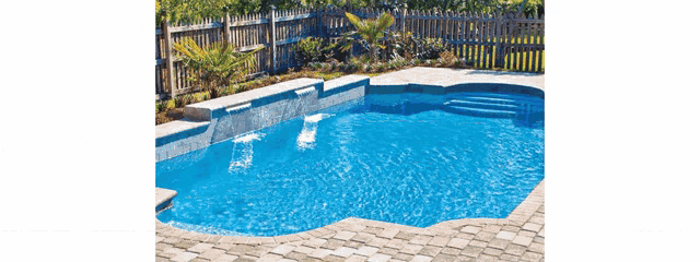 a large swimming pool with steps and a waterfall in the backyard