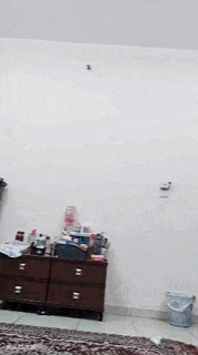 a person is standing in a room with a white wall