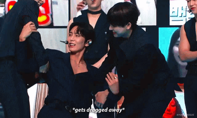 a group of young men are having fun and one of them is saying " gets dragged away "