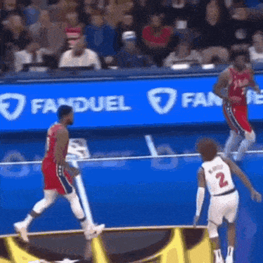 a basketball game is being played in front of a fan duel banner