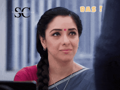 a woman with a red dot on her forehead and the word bas on the bottom right
