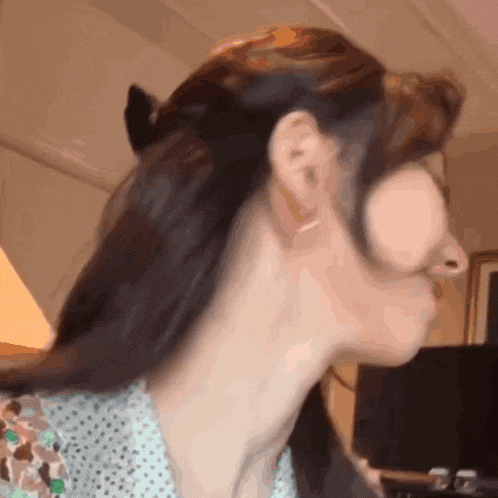 a close up of a woman 's neck with a polka dot shirt on