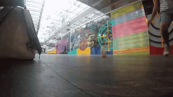 a blurred image of people walking in front of a sign that says " clash "