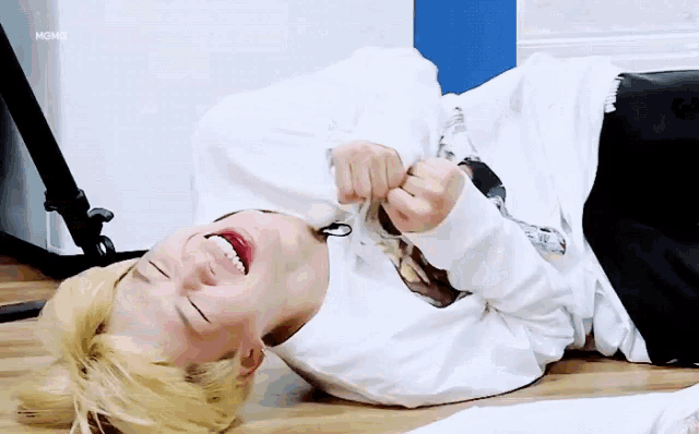 a man is laying on the floor with his mouth open and the word mgmx is visible in the corner