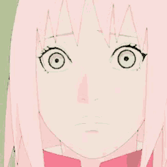a close up of a girl with pink hair and green eyes .