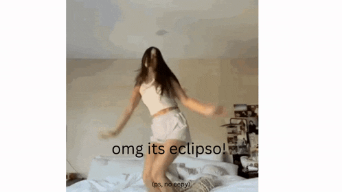a woman is jumping on a bed with the words " omg its eclipso " above her