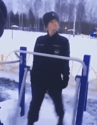 a police officer is doing pull ups in the snow .